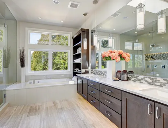 Spacious modern bathroom with large windows, bright natural light, dark wood cabinets, a white countertop, and a bathtub. Elegant, serene ambiance.