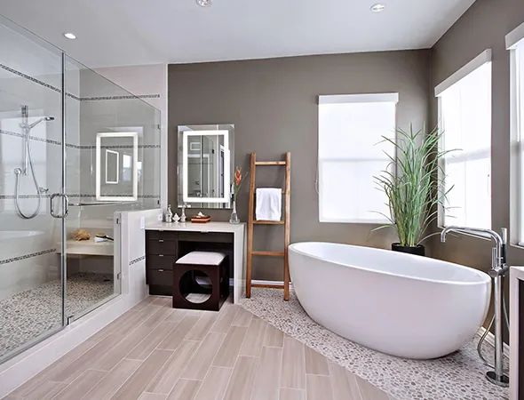 Modern bathroom with a freestanding oval tub, glass-enclosed shower, wooden vanity, and a ladder towel rack. Bright, airy, and minimalist design.