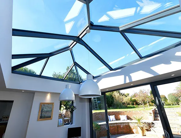 On a sunny day, the full skylight roof fills the space with warm, radiant sunlight, enhancing the bright and uplifting ambiance.