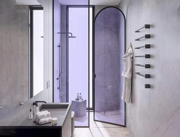 A compact bathroom with a sleek walk-in shower, frameless glass, and a neatly hung towel adding a touch of warmth and functionality.